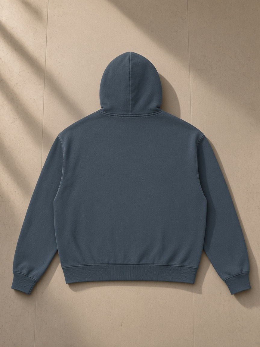 Mineral Wash Boxy Full Zip Hoodie in Navy Blue, laid flat on pale limestone, back view