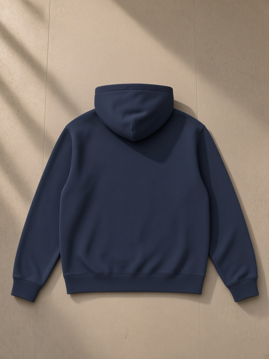 Men's Essential Heavyweight High Neck Zip-Up Hoodie in Navy Blue, laid flat on pale limestone, back view