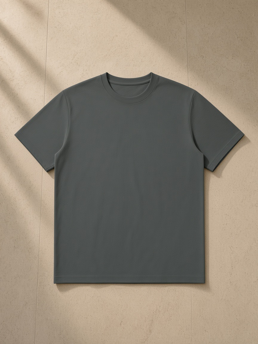 Sorona Quick-Dry Boxy T-Shirt in Dark Gray, laid flat on pale limestone