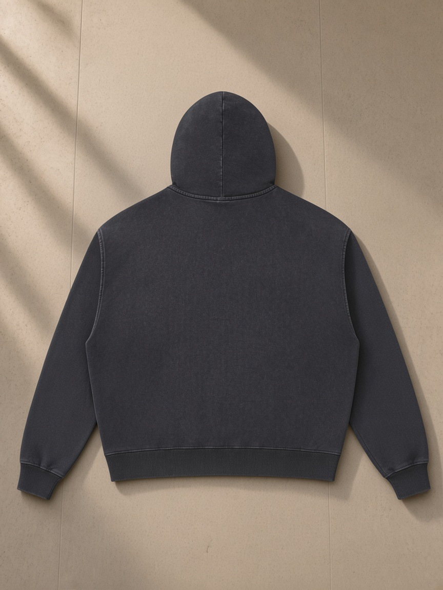 Mineral Wash Boxy Full Zip Hoodie in Dark Gray, laid flat on pale limestone, back view