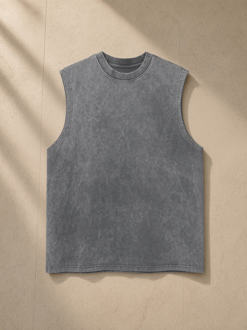 Snow Washed Frayed Hem Tank Top in Dark Gray, laid flat on pale limestone
