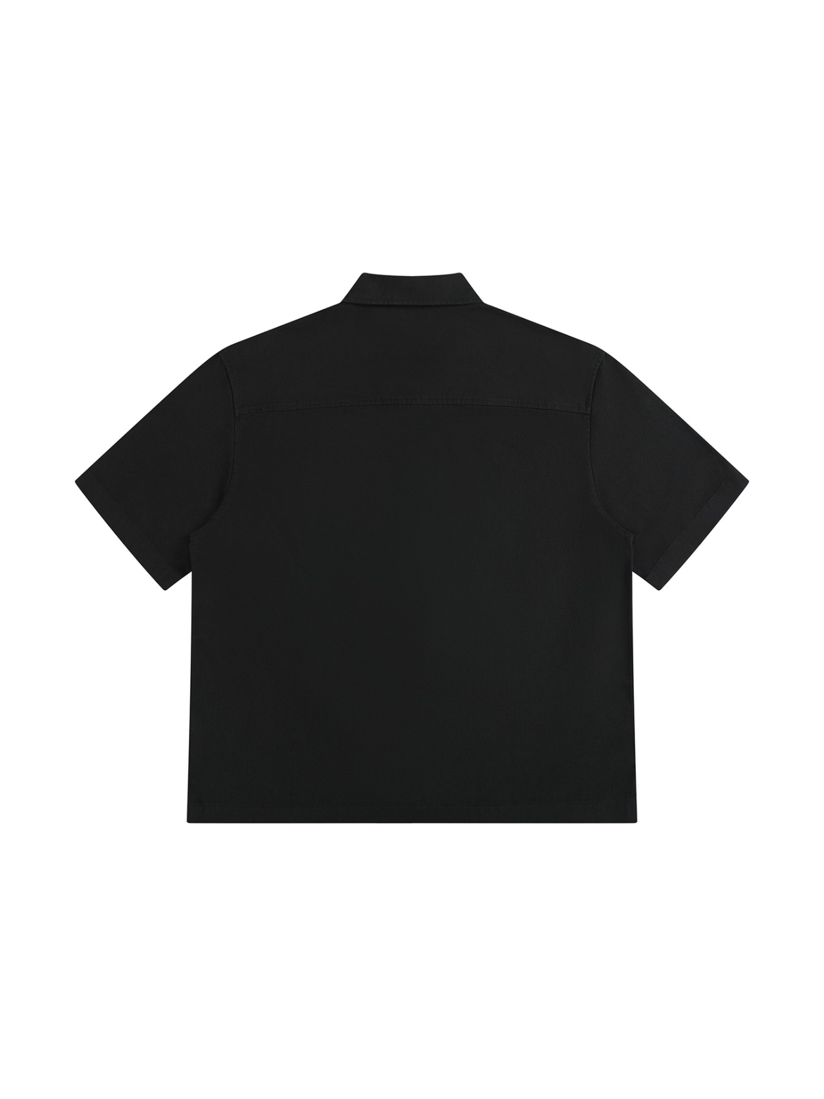 Boxy Patch Pocket Short Sleeve Shirt in Black, laid flat on pale limestone, back.