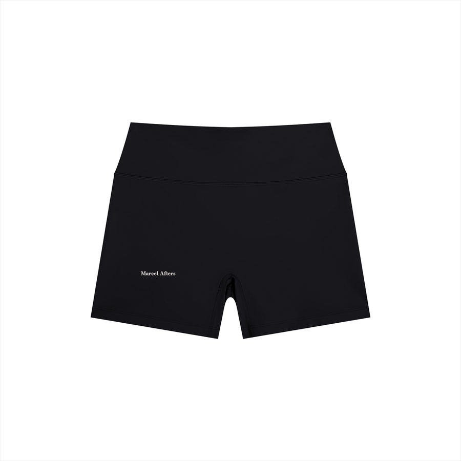 Women's High Rise Yoga Shorts in Black, front view, small Marcel Afters wordmark low on the leg above the hem.