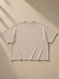 Unisex heavyweight boxy raw edge t-shirt in Khaki, laid flat on pale limestone