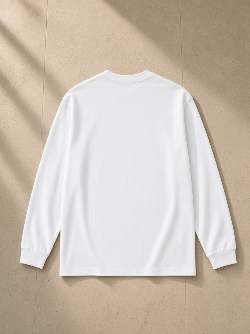 Crew Neck Drop Shoulder Long Sleeve Shirt in Basic White, laid flat on pale limestone, back.