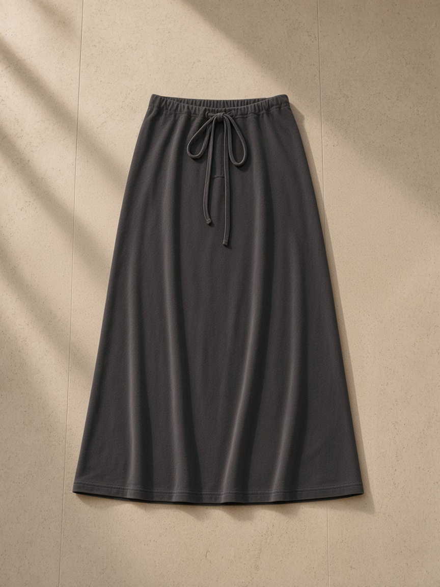 Dyed washed drawstring maxi skirt in Dark Gray, laid flat on pale limestone