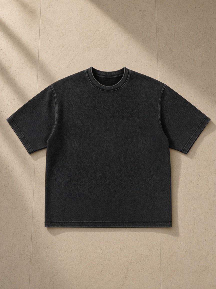 Men's Heavyweight Mineral Wash Boxy T-Shirt in Black, laid flat on pale limestone