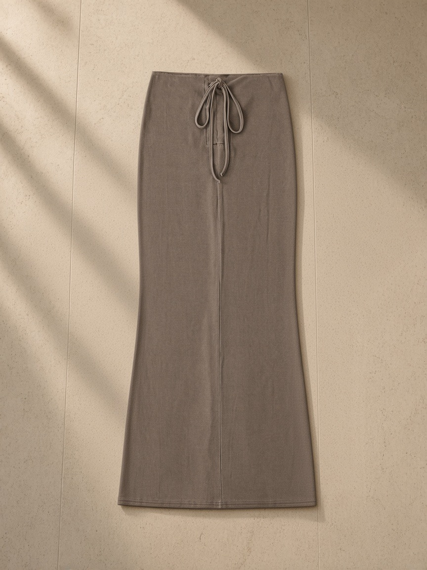 Dyed washed drawstring maxi skirt in Coffee, laid flat on pale limestone