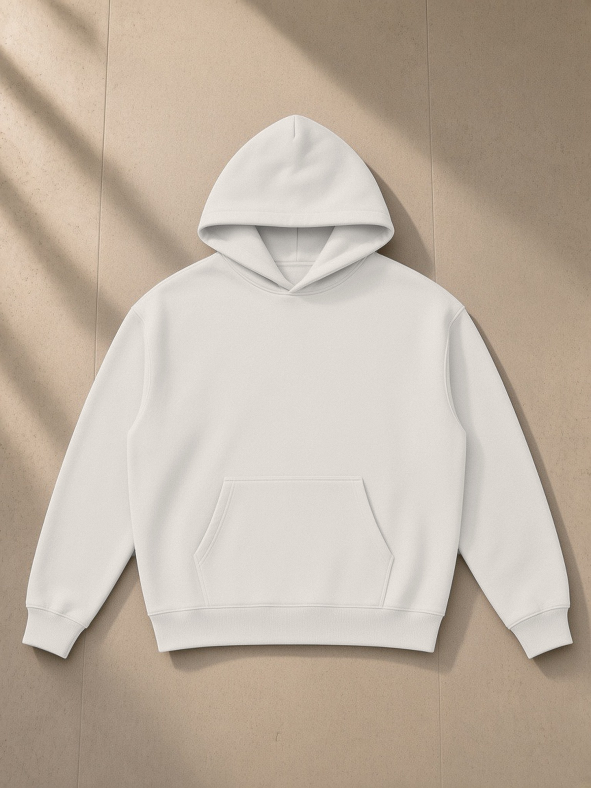 Essential Heavyweight Hoodie in Oat Gray, laid flat on pale limestone, front.