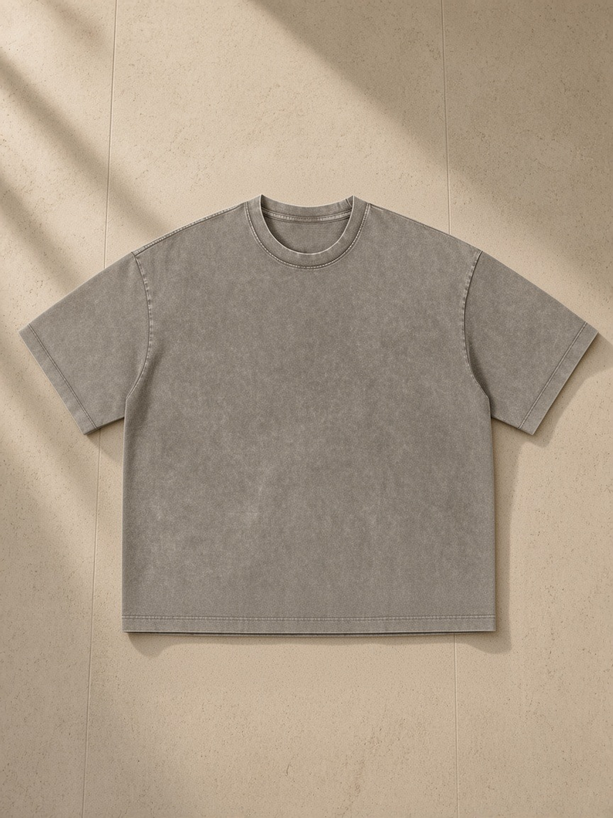 Unisex vintage wash boxy t-shirt in Light Coffee, laid flat on pale limestone