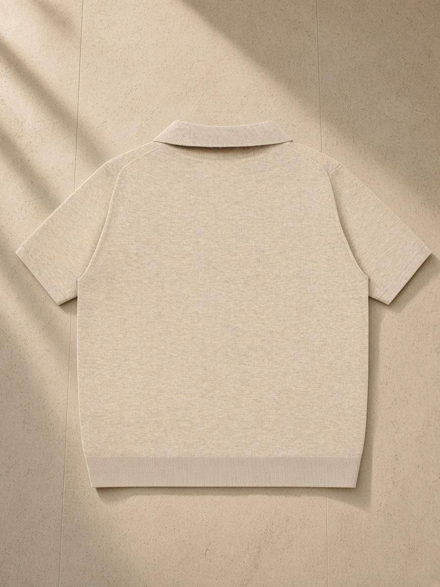 Heavyweight Oversized Polo in Mild Apricot, laid flat on pale limestone, back view