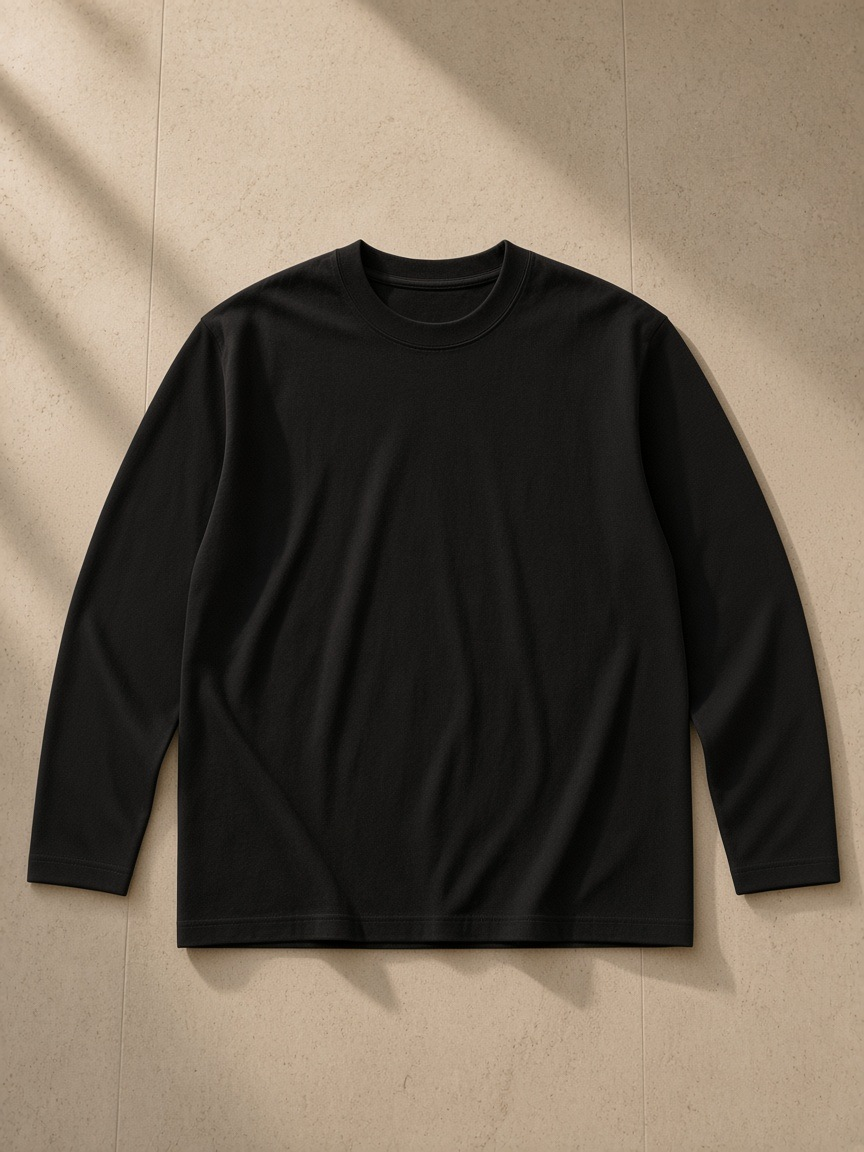 Heavyweight Long Sleeve T-Shirt in Black, laid flat on pale limestone
