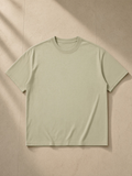 Unisex Mineral Wash Oversized T-Shirt in Apricot, laid flat on pale limestone