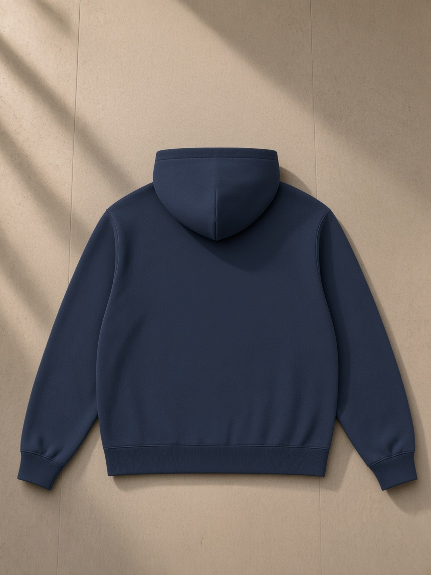 Unisex regular fit full zip hoodie in Navy Blue, laid flat on pale limestone, back view
