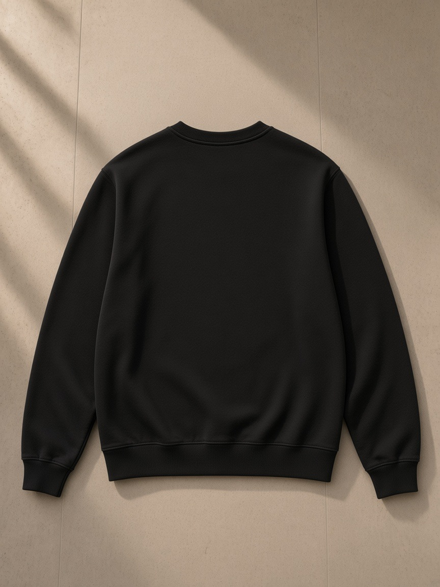 Streetwear Cotton Pullover in Black Beauty, laid flat on pale limestone, back view