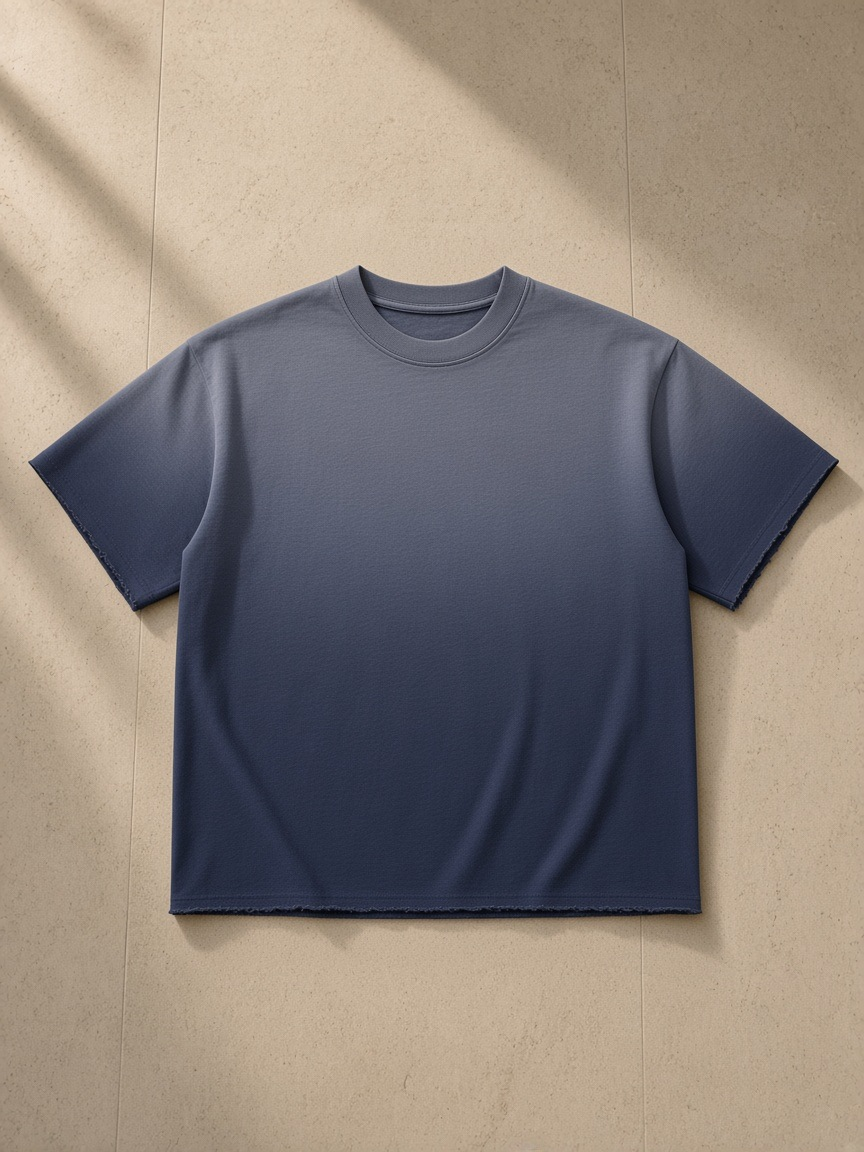 Men's sun fade raw edge t-shirt in Navy Blue, laid flat on pale limestone