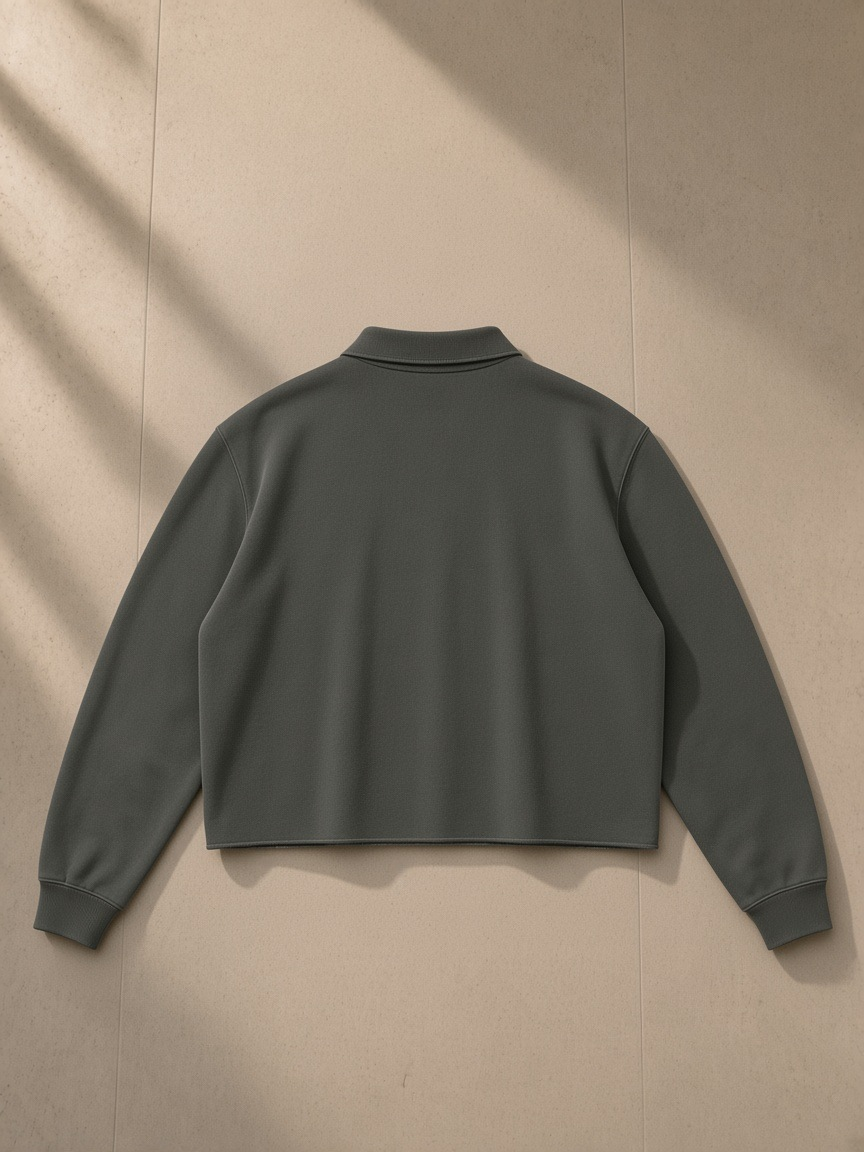 Mineral Wash Pullover Sweatshirt in Dark Gray, laid flat on pale limestone, back view