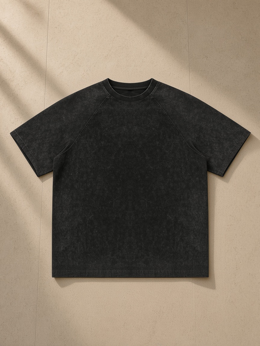 Unisex mineral wash raw edge t-shirt in Black, front view on white. Marcel Afters
