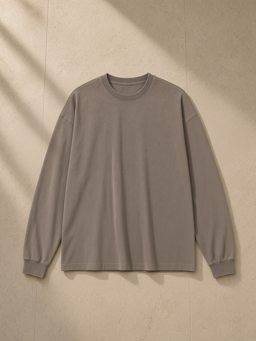 Vintage Washed Long Sleeve T-Shirt in Brown, laid flat on pale limestone