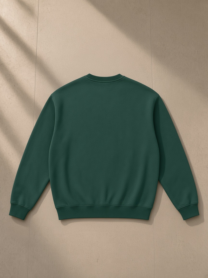 Fleeced sweatshirt in Eden Green, laid flat on pale limestone, back view