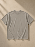 Enzyme Washed T-Shirt in Khaki, laid flat on pale limestone