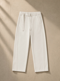 Women's belted barrel-leg chino pants in Beige, laid flat on pale limestone