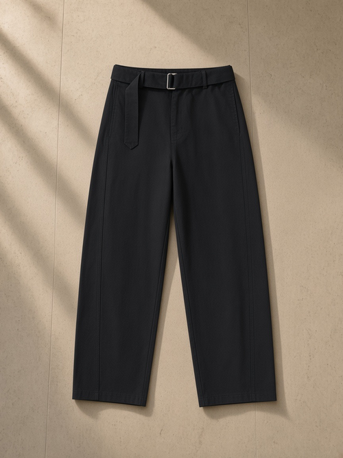 Women's belted barrel-leg chino pants in Black, laid flat on pale limestone