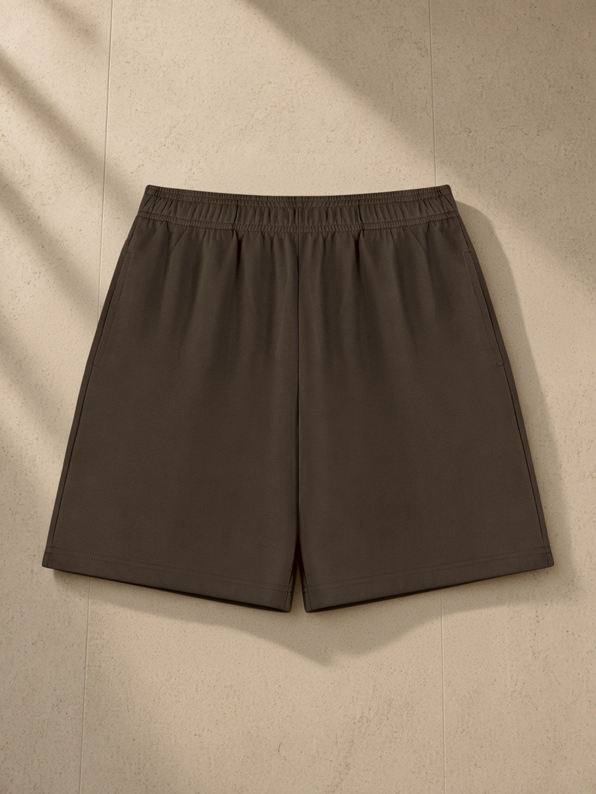 Cotton Shorts in Coffee, laid flat on pale limestone