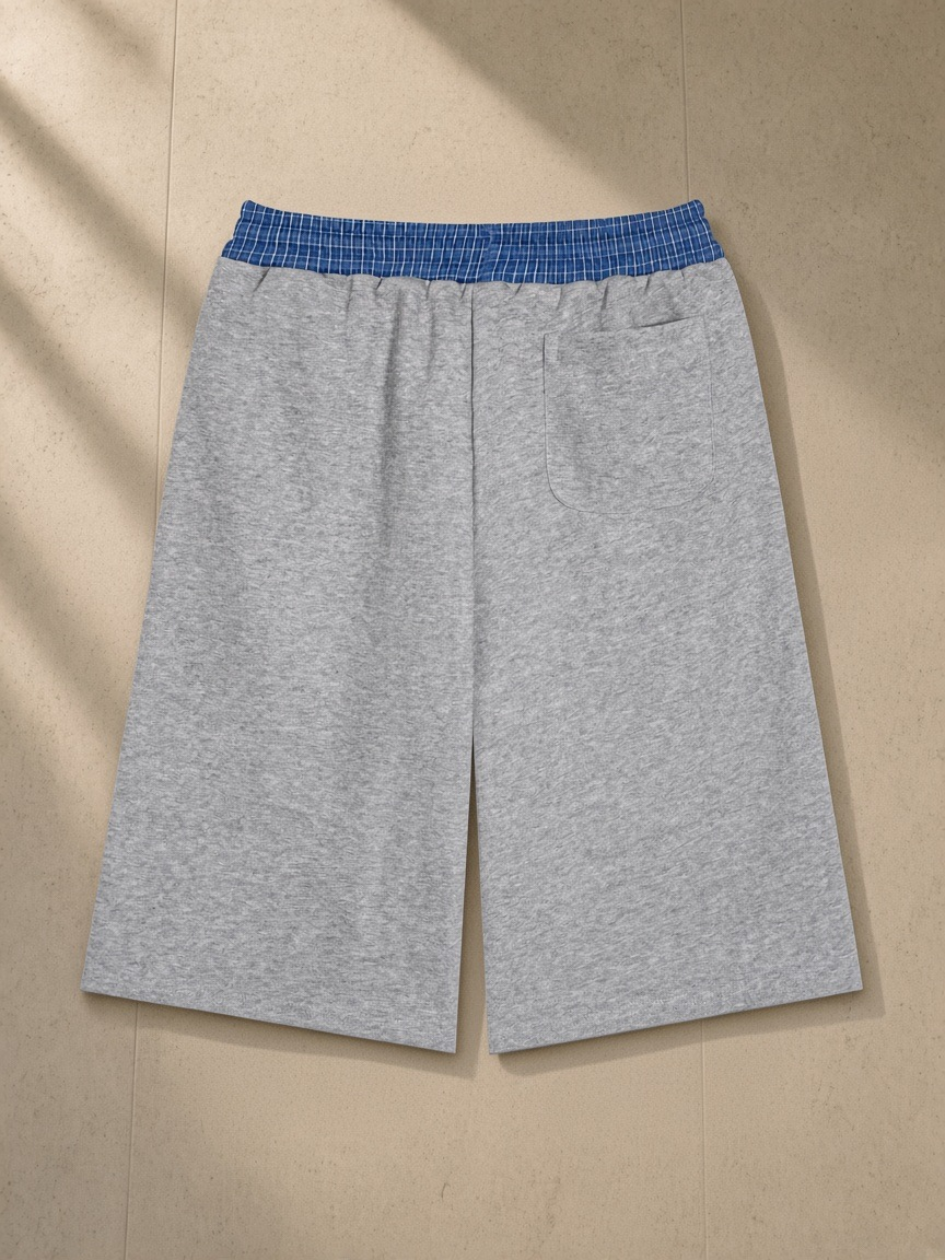 Plaid Waistband Shorts in Flower Gray, laid flat on pale limestone, back view