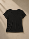 Tencel slim fit v-neck t-shirt in Black, laid flat on pale limestone