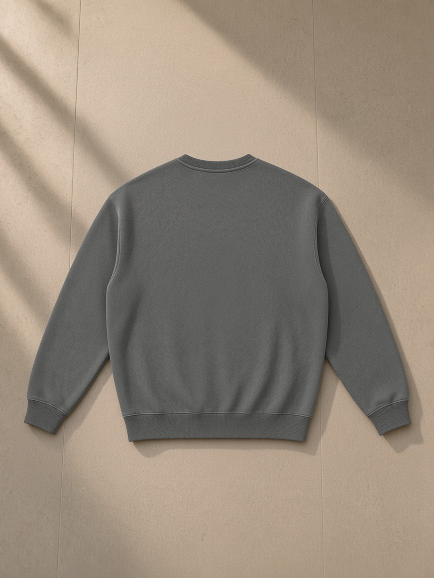 Fleeced sweatshirt in Gray, laid flat on pale limestone, back view