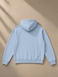 Unisex heavyweight raglan sleeve zip hoodie in Blue, laid flat on pale limestone, back view