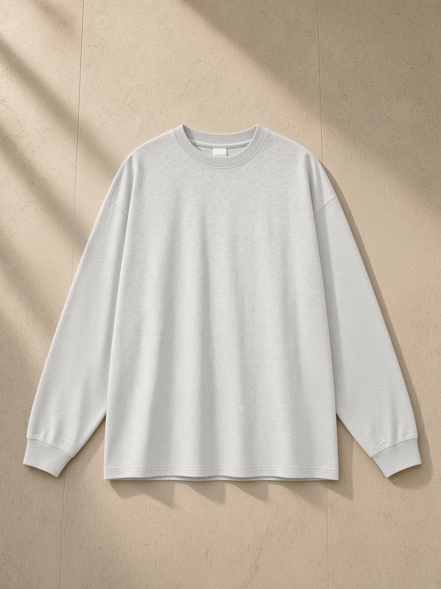 Oversized Long Sleeve T-Shirt in Oat Gray, laid flat on pale limestone