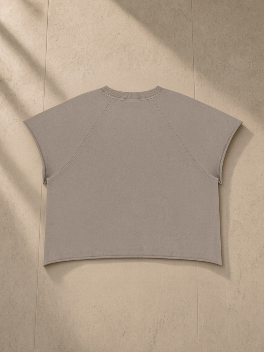 Vintage Wash Raw Edge Boxy T-Shirt in Khaki Ash, laid flat on pale limestone, back.