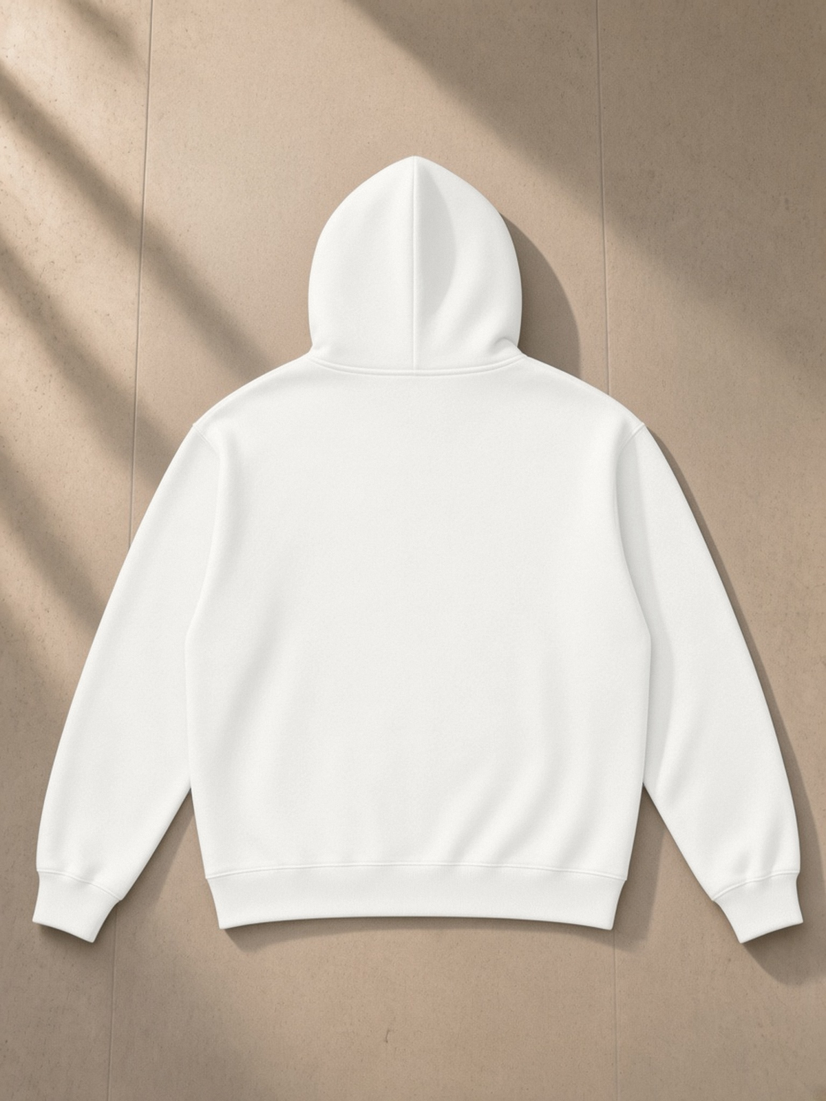 Relaxed Fit Hoodie in Oat Gray, laid flat on pale limestone, back.