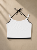 Women's Contrast Binding Halter Top in White, laid flat on pale limestone