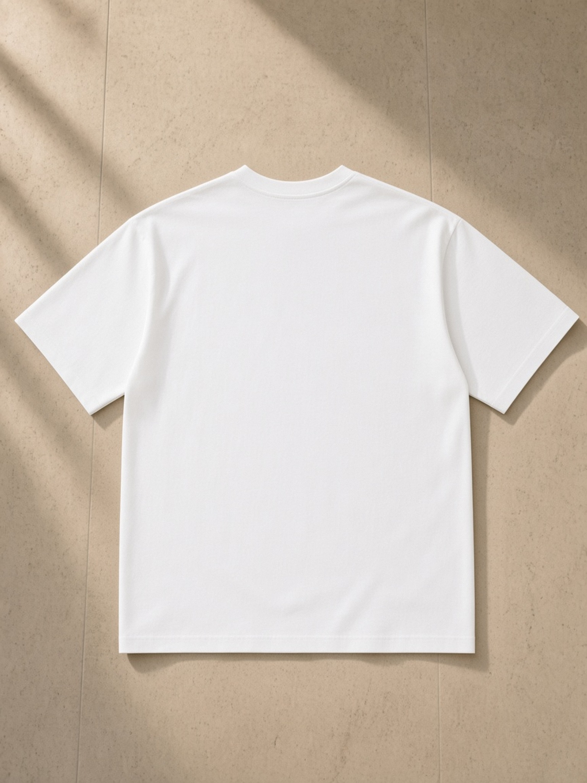 Sorona Quick-Dry T-Shirt in White, laid flat on pale limestone, back.