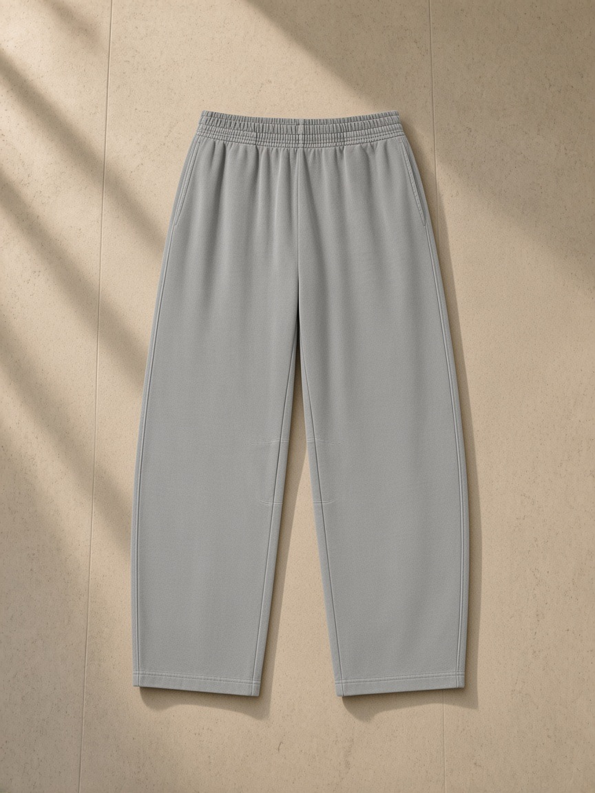 Vintage washed barrel leg sweatpants in Light Gray, laid flat on pale limestone