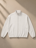 Heavyweight Stand Collar Jacket in Oat Gray, laid flat on pale limestone