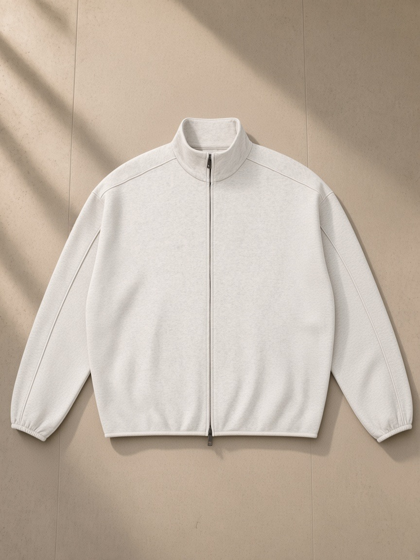 Heavyweight Stand Collar Jacket in Oat Gray, laid flat on pale limestone