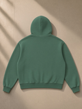 Vintage Wash Boxy Fleece Hoodie in Dark Green, laid flat on pale limestone, back view