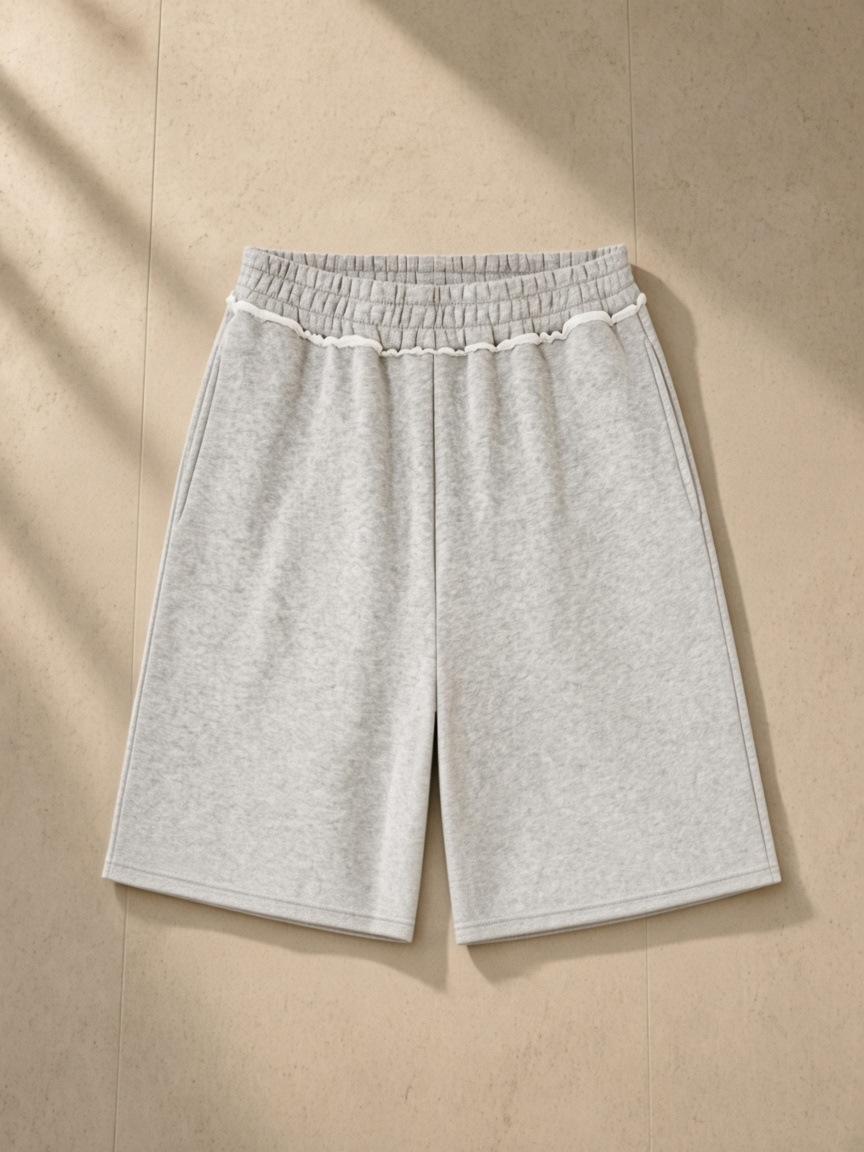 Raw Edge Fleece Shorts in Flower Gray, laid flat on pale limestone, back.