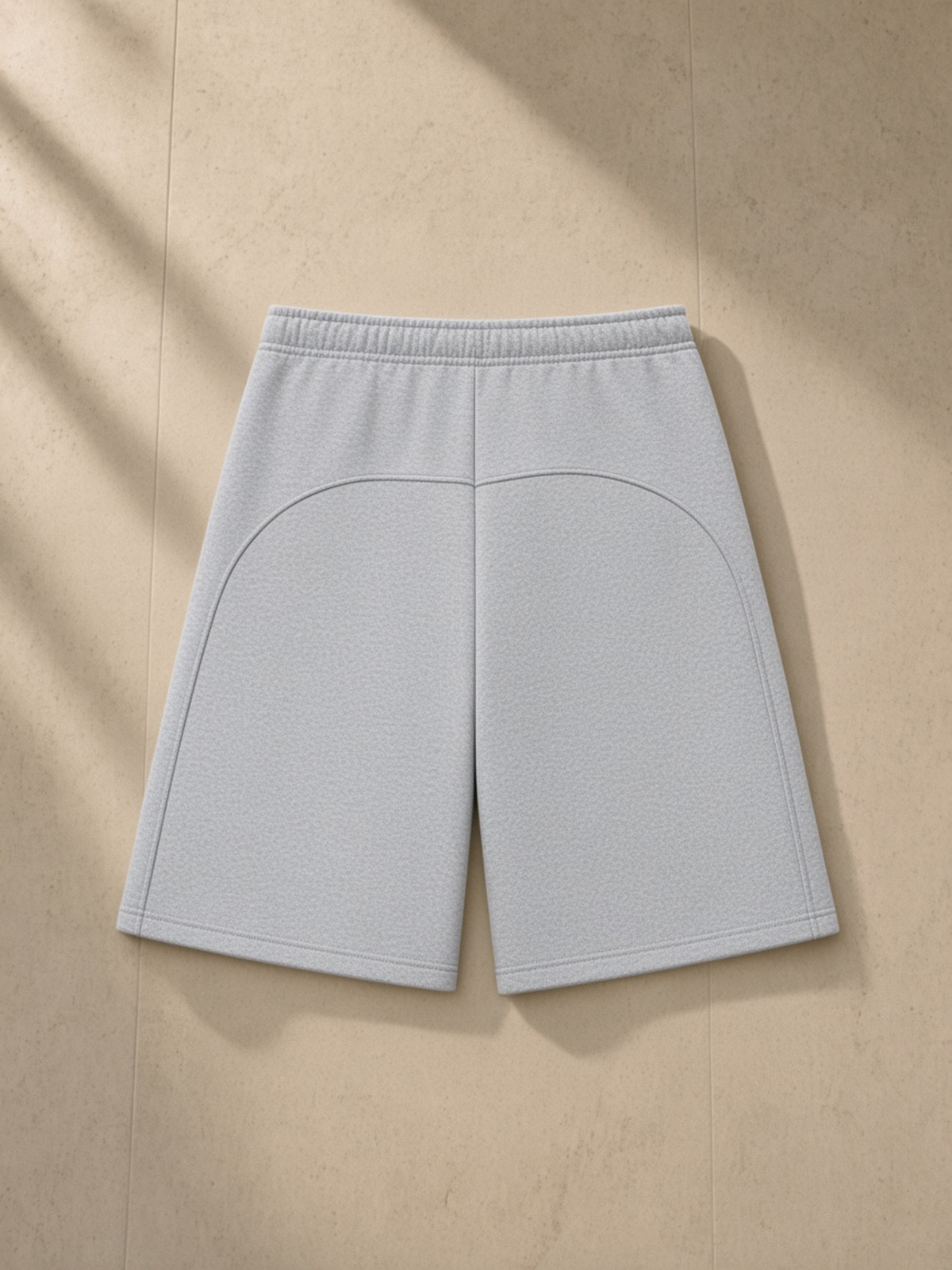 Essential Heavyweight Fleece Shorts in Flower Gray, laid flat on pale limestone, back.