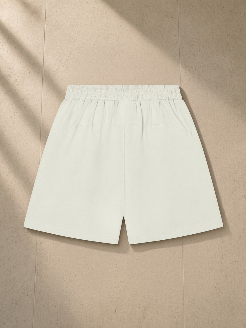 Unisex regular fit shorts in White Gray, laid flat on pale limestone, back view