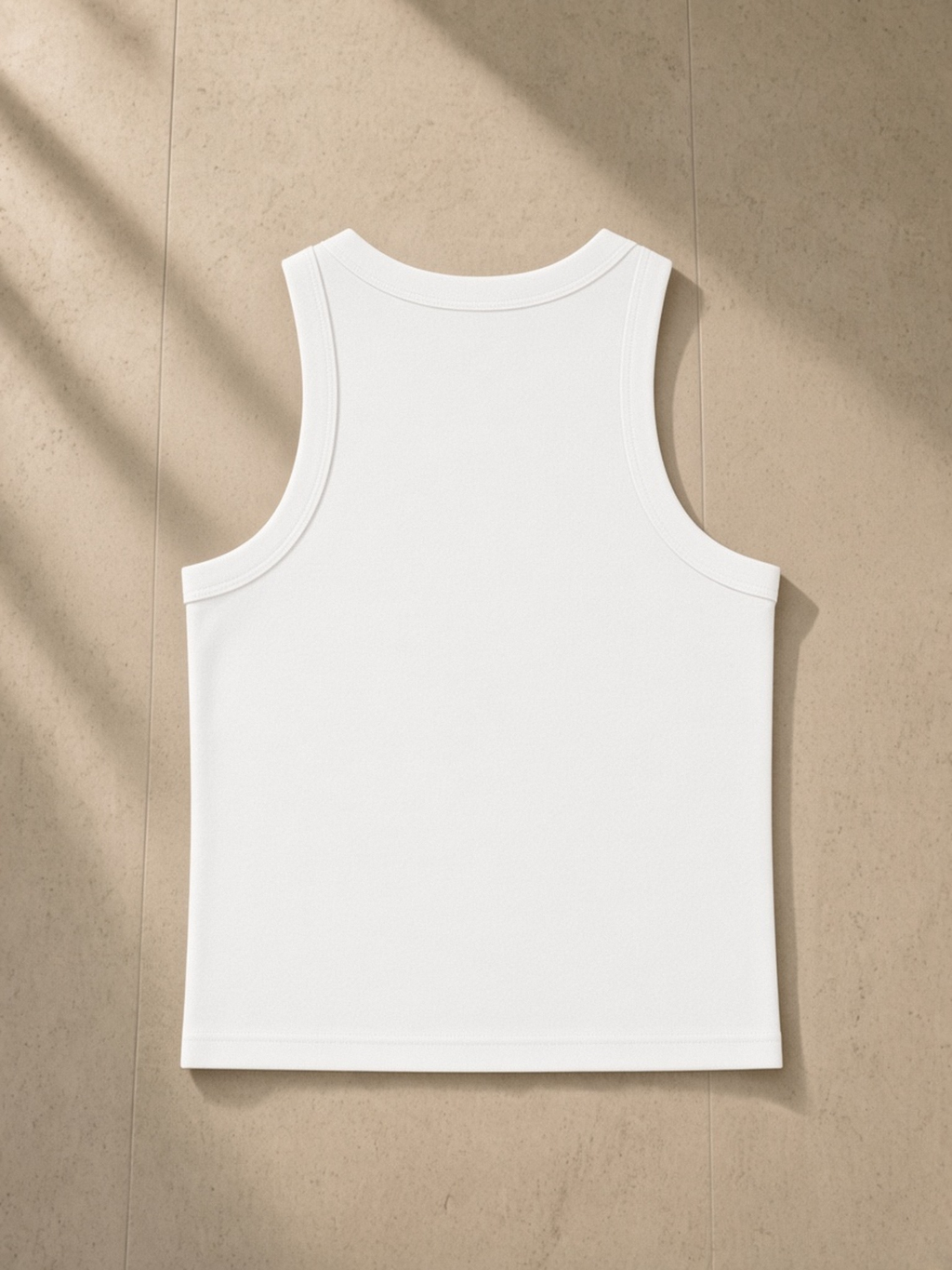Snow Washed Tank Top in White, laid flat on pale limestone, back.