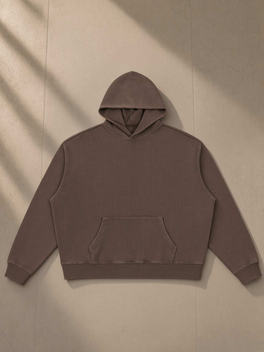 Vintage Wash Waffle Boxy Hoodie in Brown, laid flat on pale limestone, front.