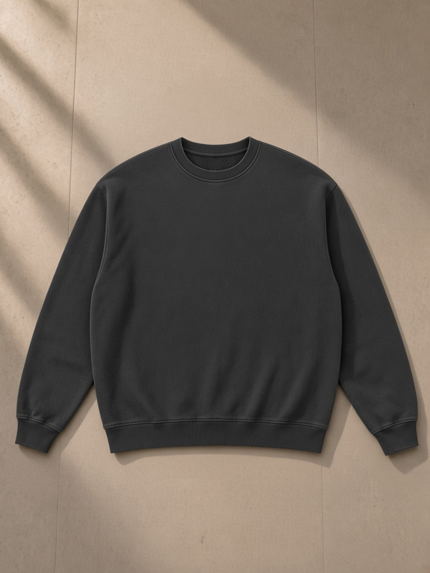 Vintage Wash Fleece Sweatshirt — Dark in Black, laid flat on pale limestone, front.