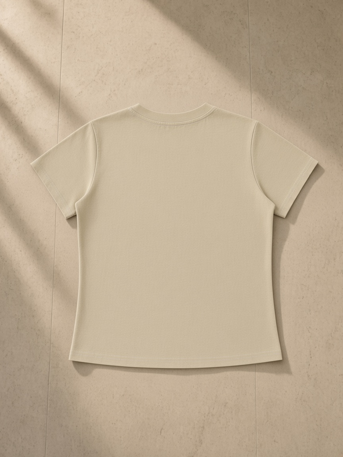 Vintage Wash Slim Fit T-shirt in Khaki, laid flat on pale limestone, back.