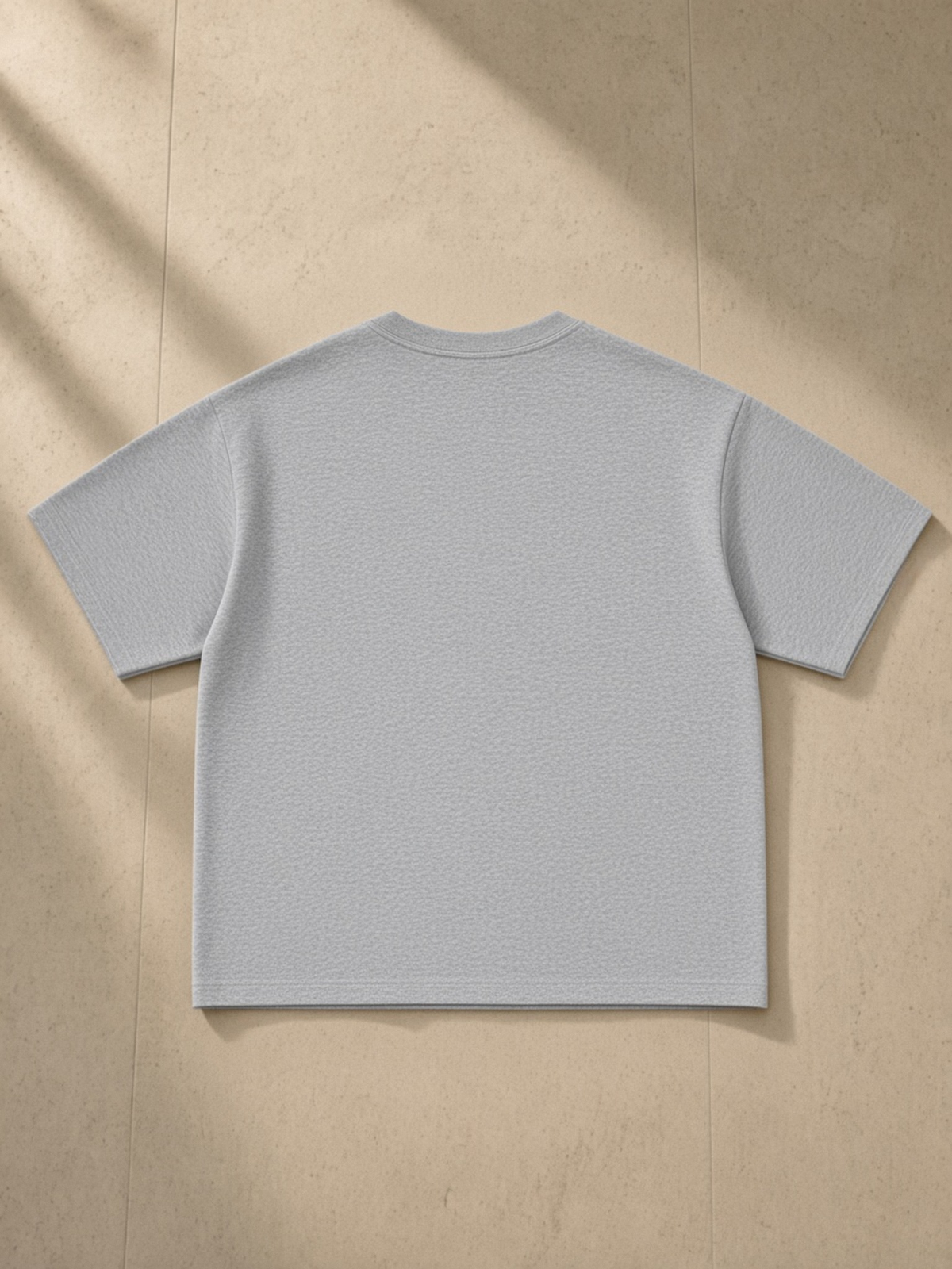 Essential Sorona Boxy T-Shirt in Flower Gray, laid flat on pale limestone, back.