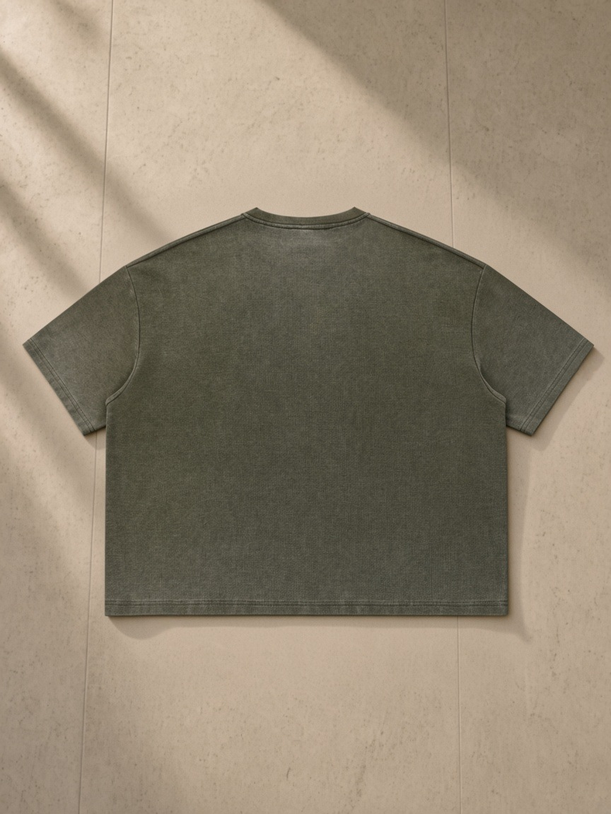 Vintage Wash Sunfade Boxy Waffle T-Shirt in Army Green, laid flat on pale limestone, back.